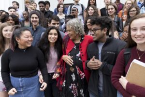 Charlayne smiling with students